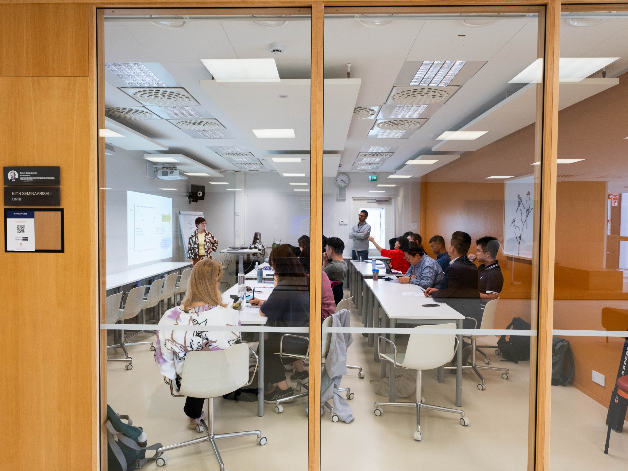 Education session observed through a glass classroom wall