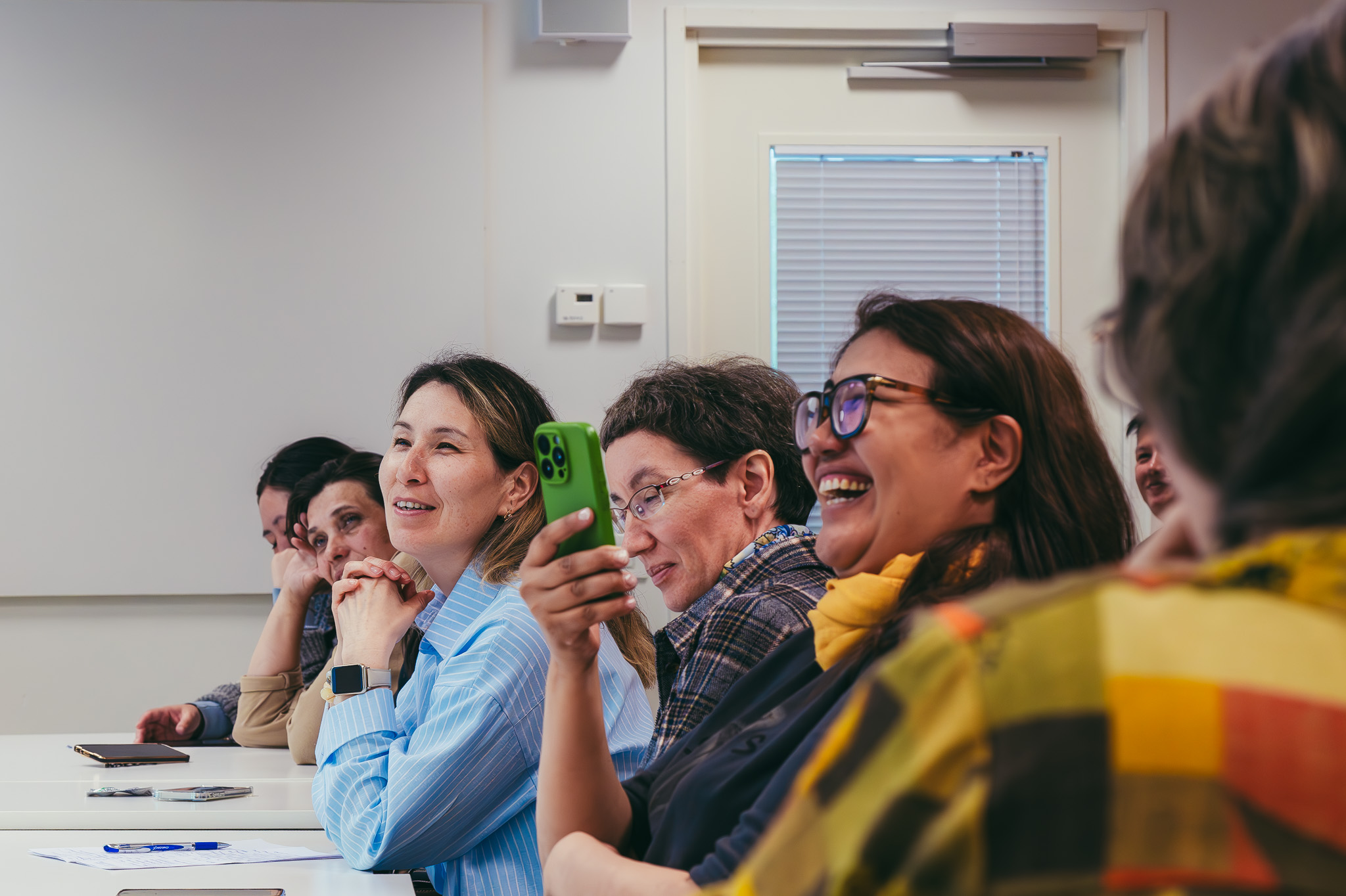 Participants smiling during an academic session